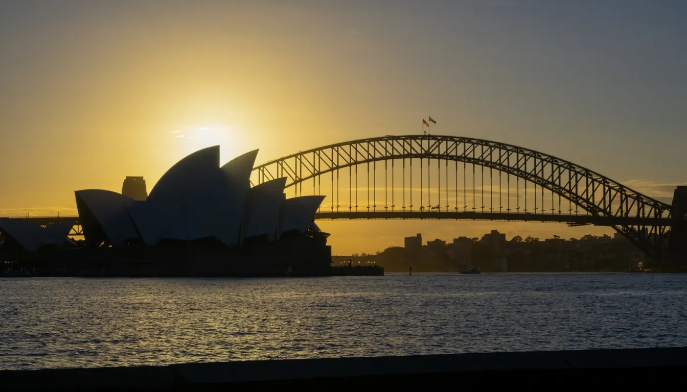 Sydney Harbour and the Opera House seen across the water at sunset